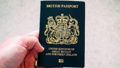 A man holding a passport for UK immigration process