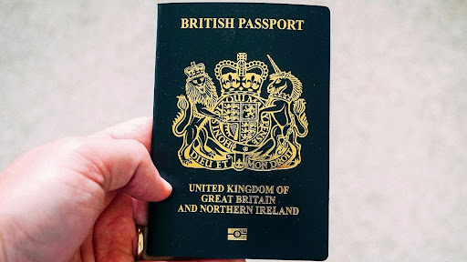 A man holding a passport for UK immigration process